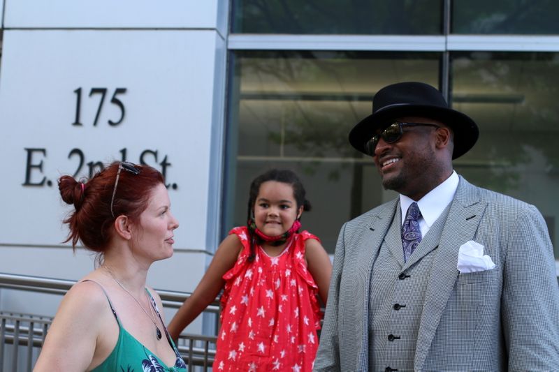 Rev. Dr. Robert Turner of the Historic Vernon Chapel A.M.E. Church speaks with local resident Marta Reiman, 40, and her niece Allayah Reed, 8,  as he holds his weekly Reparations March ahead of the 100 year anniversary of the 1921 Tulsa Massacre in Tulsa, Oklahoma, U.S., May 26, 2021.  REUTERS/Polly Irungu