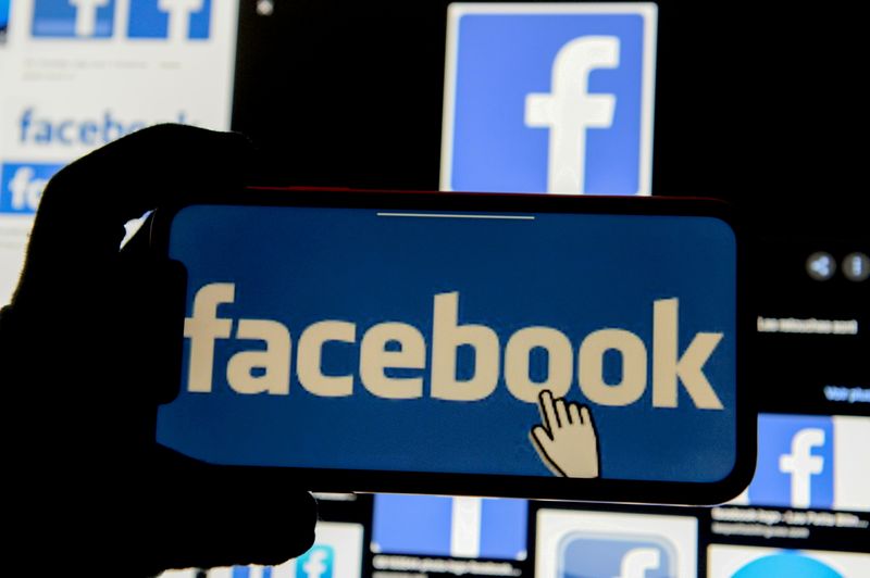 The Facebook logo is displayed on a mobile phone in this picture illustration taken December 2, 2019. REUTERS/Johanna Geron/Illustration/File Photo