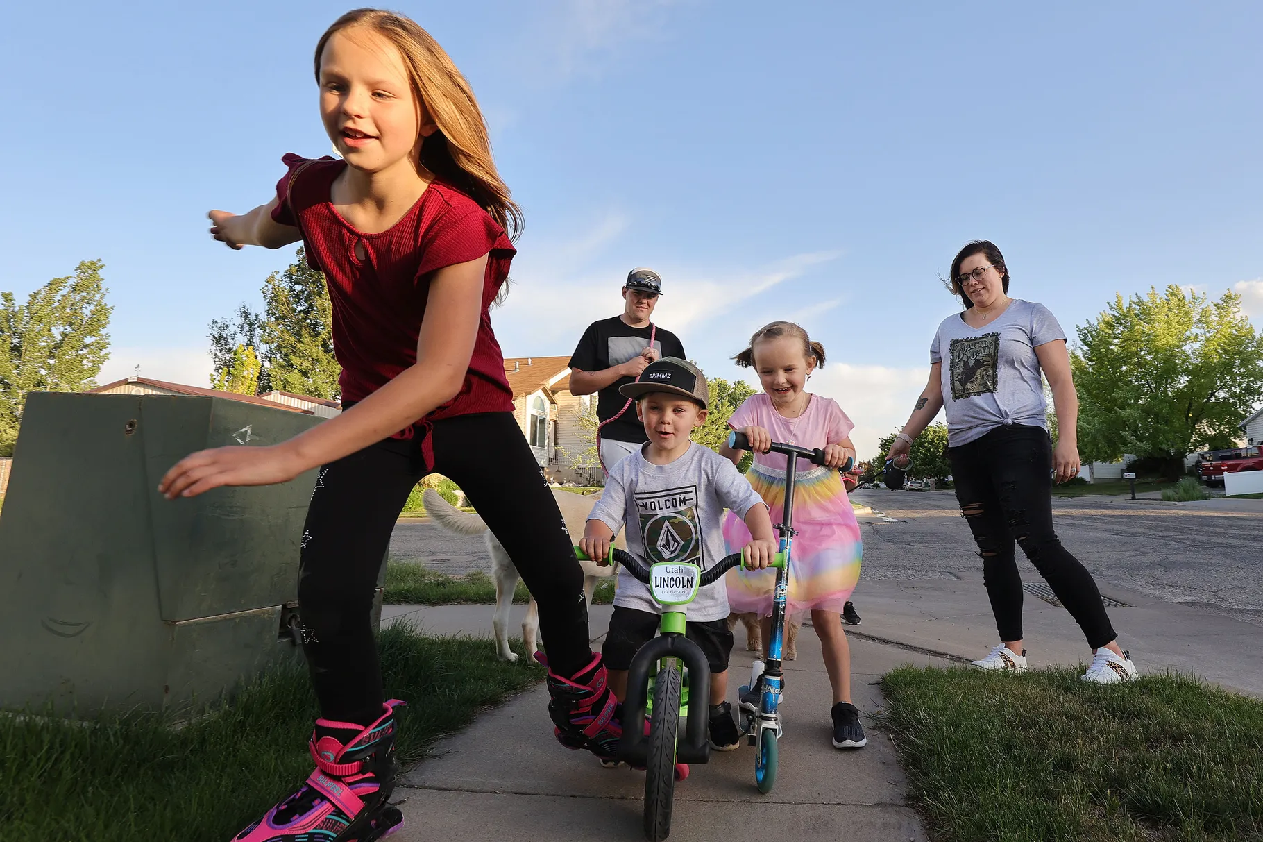 Tyler and Stephanie Parkin walk and bike with their children near their home in Roy on Thursday, May 20, 2021. The Parkins say they severely limit screen use by their children. 
