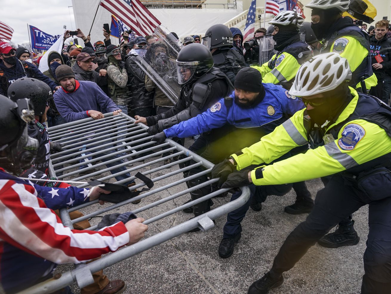 Trump supporters beset a police barrier at the Capitol
in Washington on Wednesday Jan. 6, 2021, A 19th person from Ohio
has been arrested in Alabama for allegedly convening a caravan of
people from Virginia to Washington on Jan. 6 and assaulting police
officers during the deadly Capitol riots.