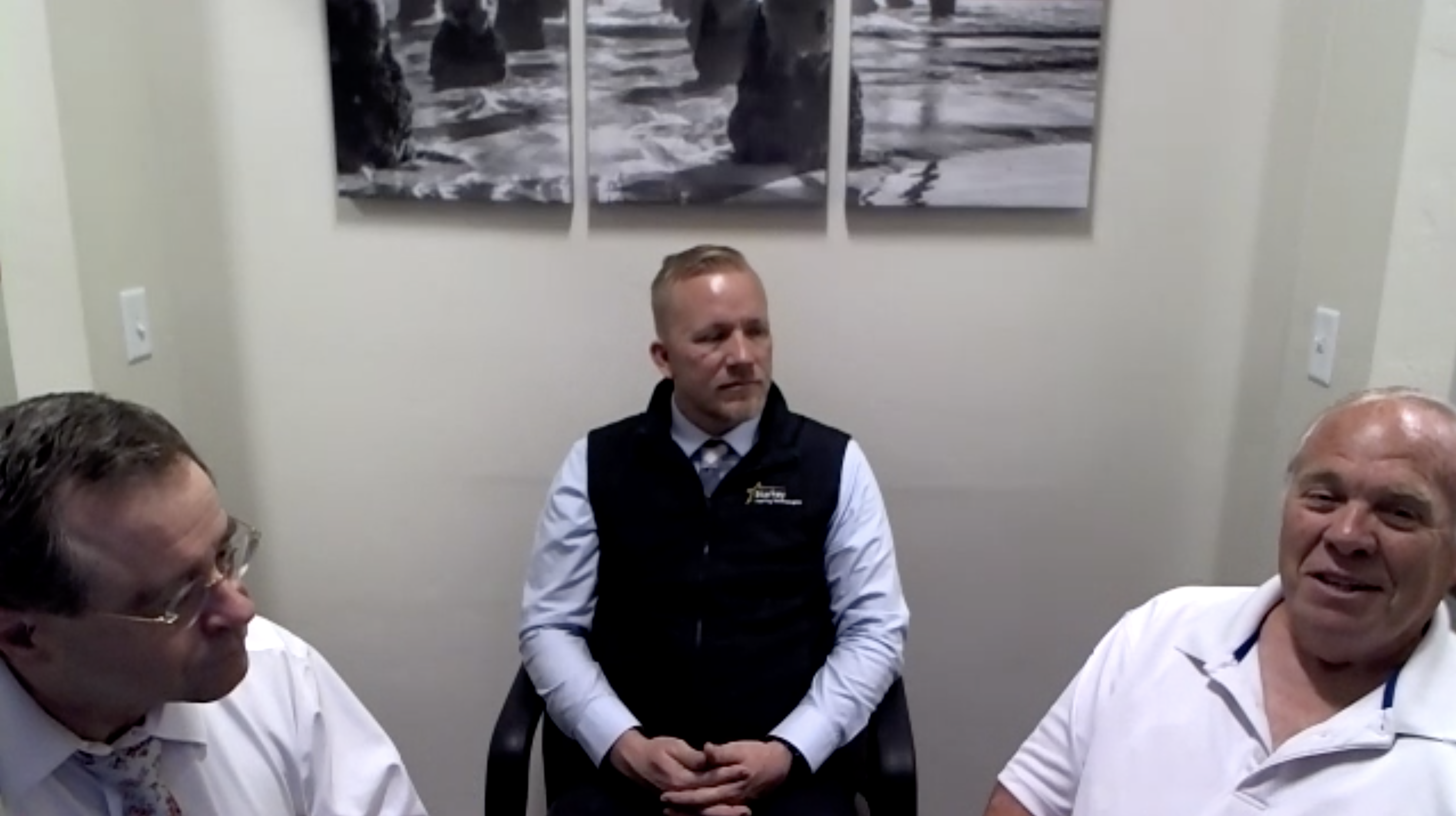 Military veteran David Miller, right, pictured with audiologist Kimball Forbes, left, and Starkey representative Erek Winnett, middle, talks about receiving a donated pair of hearing aids on Friday, May 28, 2021, after his previous pair was lost. 