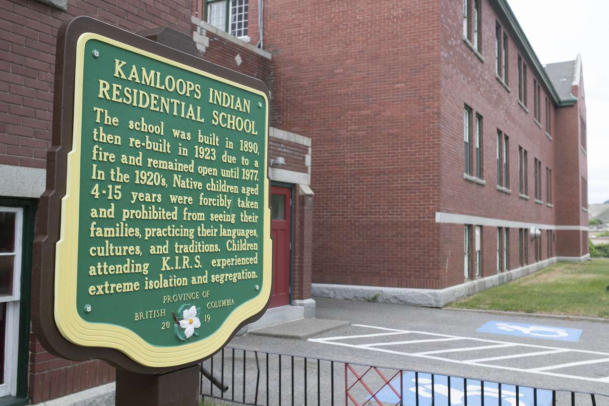 A plaque is seen outside of the former Kamloops Indian Residential School on Tk'emlups te Secwépemc First Nation in Kamloops, British Columbia, Canada on Thursday, May 27, 2021. The remains of 215 children have been found buried on the site of the former residential school in Kamloops.