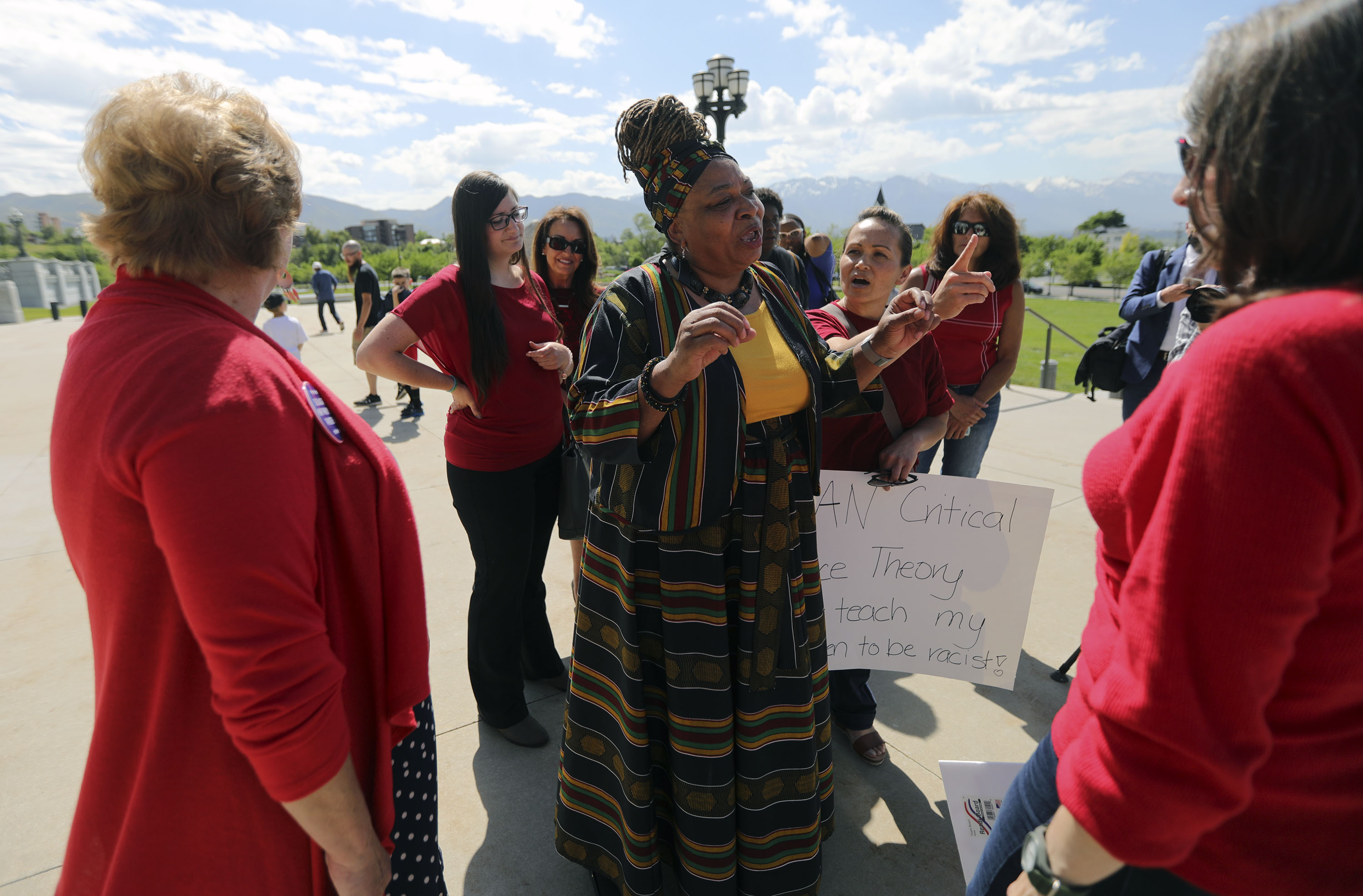 Betty Sawyer, a supporter of critical race theory, center, exchanges views with a group of women opposed to the theory, after a protest organized by the Utah Educational Equity Coalition outside of the Capitol in Salt Lake City on Wednesday, May 19, 2021. Community activists and educators protested Utah lawmakersâ plans to pass resolutions encouraging a ban of critical race theory concepts in an extraordinary session scheduled later Wednesday.