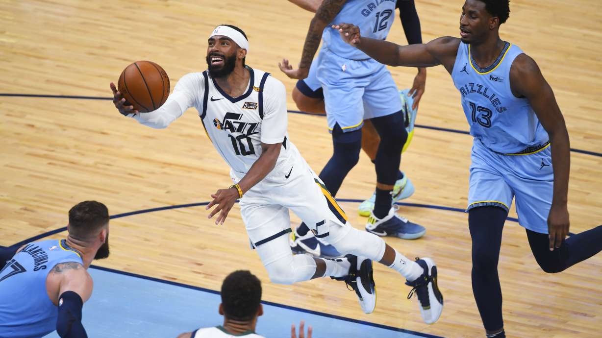 Utah Jazz guard Mike Conley (10) goes to the basket past Memphis Grizzlies forward Jaren Jackson Jr. (13) during the second half of Game 3 of an NBA basketball first-round playoff series Saturday, May 29, 2021, in Memphis, Tenn. Utah won 121-111. (AP Photo/John Amis)