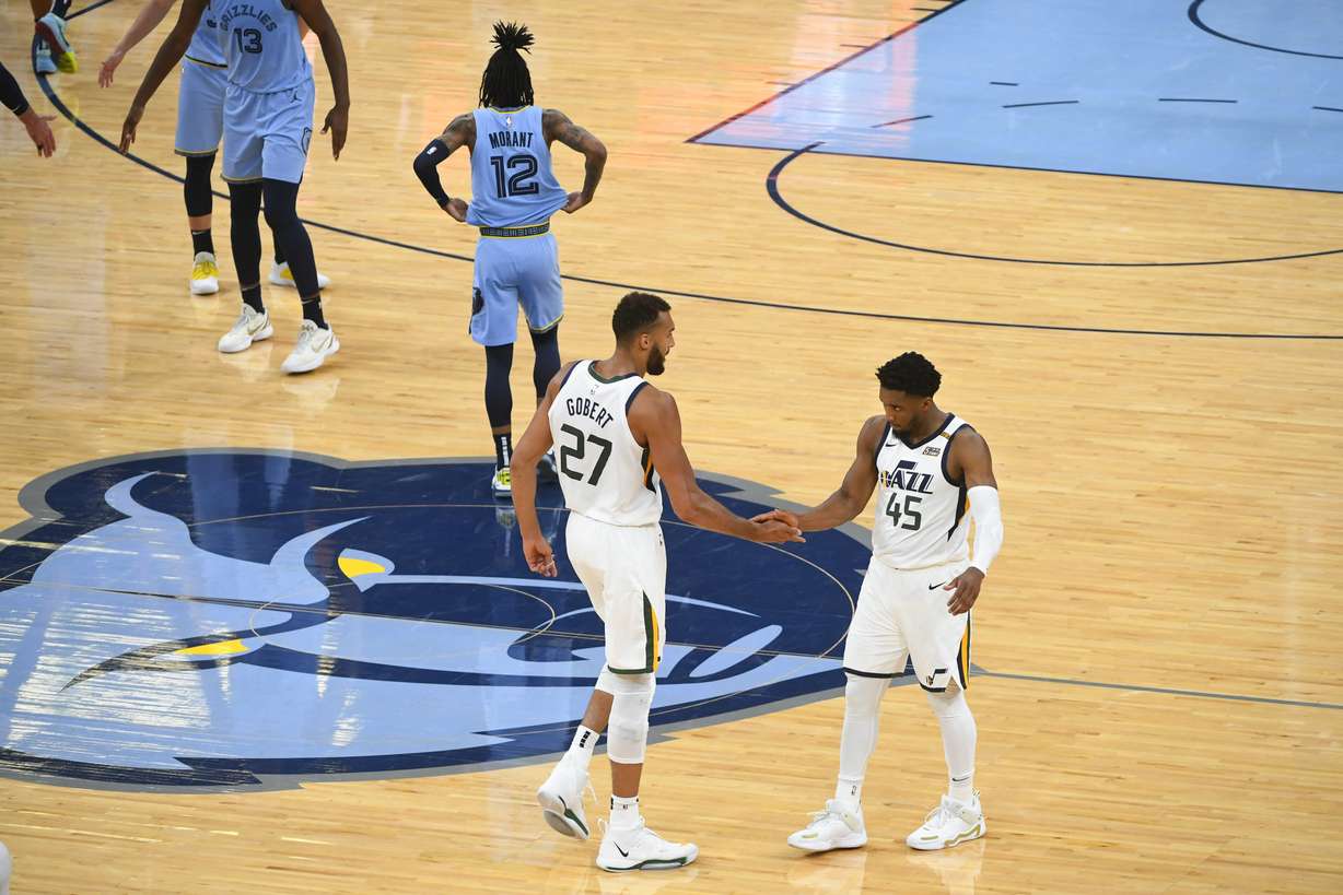 Utah Jazz center Rudy Gobert (27) and guard Donovan Mitchell (45) congratulate each other at the end of Game 3 of an NBA basketball first-round playoff series against the Memphis Grizzlies, Saturday, May 29, 2021, in Memphis, Tenn. Utah won 121-111.