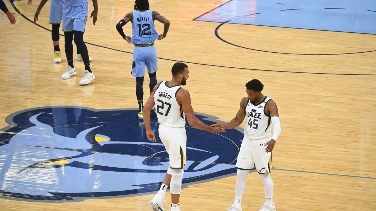Utah Jazz center Rudy Gobert (27) and guard Donovan Mitchell (45) congratulate each other at the end of Game 3 of an NBA basketball first-round playoff series against the Memphis Grizzlies, Saturday, May 29, 2021, in Memphis, Tenn. Utah won 121-111. (AP Photo/John Amis)
