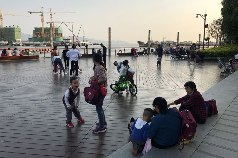 FILE PHOTO: Children play at a waterfront in Shekou area of Shenzhen, Guangdong province, China March 15, 2021. REUTERS/David Kirton