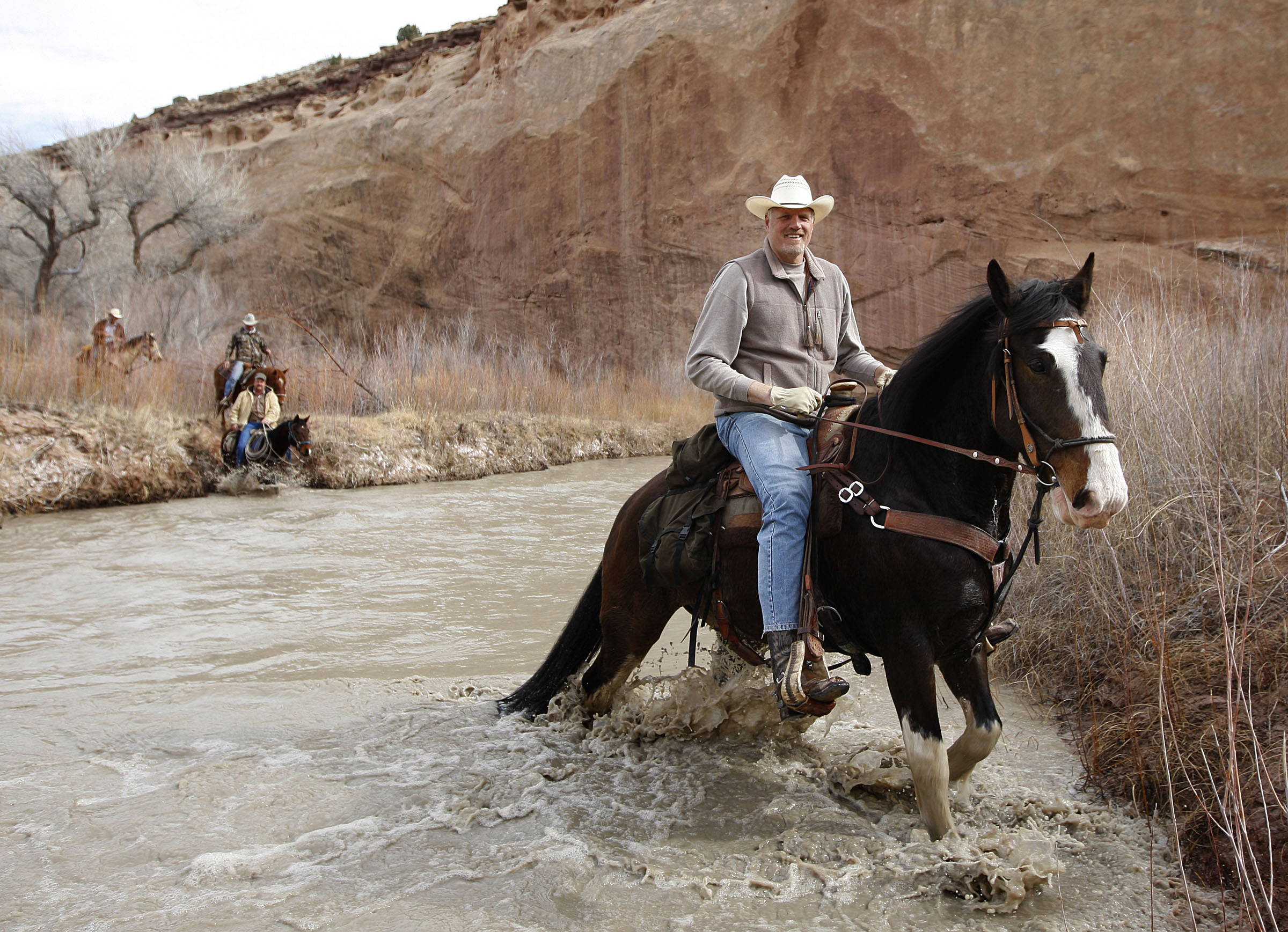 Former 7'4" Utah Jazz center Mark Eaton  rides his Clydesdale/Thoroughbred horse "Big Tim" is swept down the San Rafael River after hitting a deep hole while while riding horses down the Little Grand Canyon of the San Rafael Swell  Saturday, April 2, 2011, in the San Rafael Swell in Central Utah.  (Tom Smart, Deseret News)