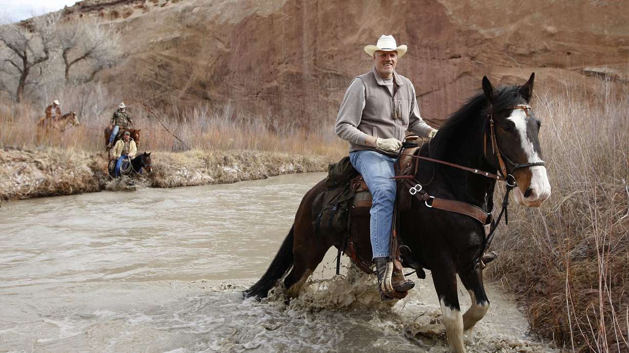 Former 7'4" Utah Jazz center Mark Eaton rides his Clydesdale/Thoroughbred horse "Big Tim" is swept down the San Rafael River after hitting a deep hole while while riding horses down the Little Grand Canyon of the San Rafael Swell Saturday, April 2, 2011, in the San Rafael Swell in Central Utah. (Tom Smart, Deseret News)