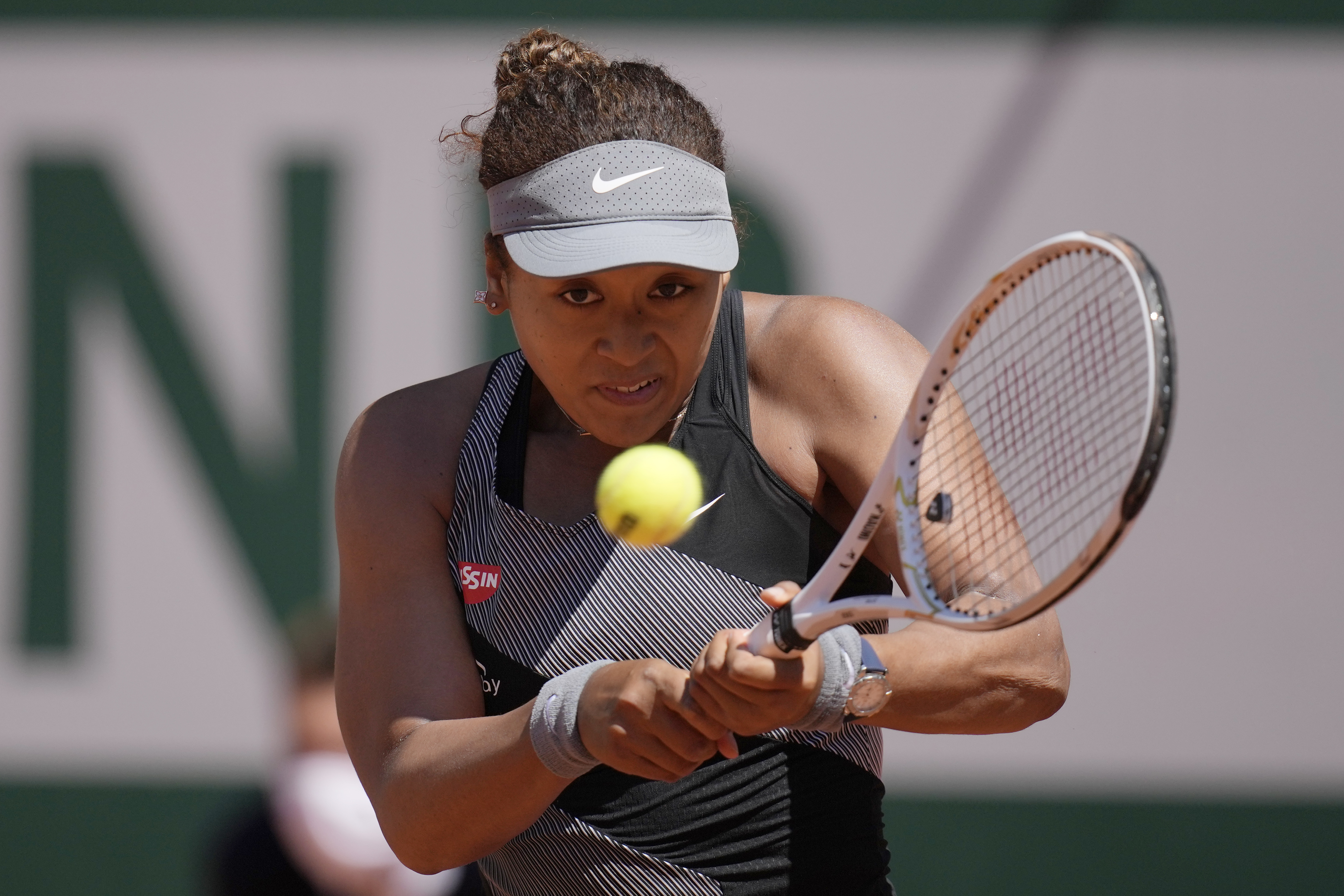 Japan's Naomi Osaka returns the ball to Romania's Patricia Maria Tig during their first round match of the French open tennis tournament at the Roland Garros stadium Sunday, May 30, 2021 in Paris. (AP Photo/Christophe Ena) [May-31-2021]