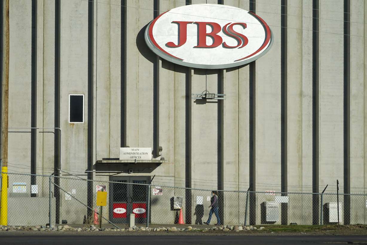 In this Oct. 12, 2020 file photo, a worker heads into the JBS meatpacking plant in Greeley, Colo. A weekend ransomware attack on the world’s largest meat company is disrupting production around the world just weeks after a similar incident shut down a U.S. oil pipeline. The White House confirms that Brazil-based meat processor JBS SA notified the U.S. government Sunday, May 30, 2021, of a ransom demand from a criminal organization likely based in Russia.