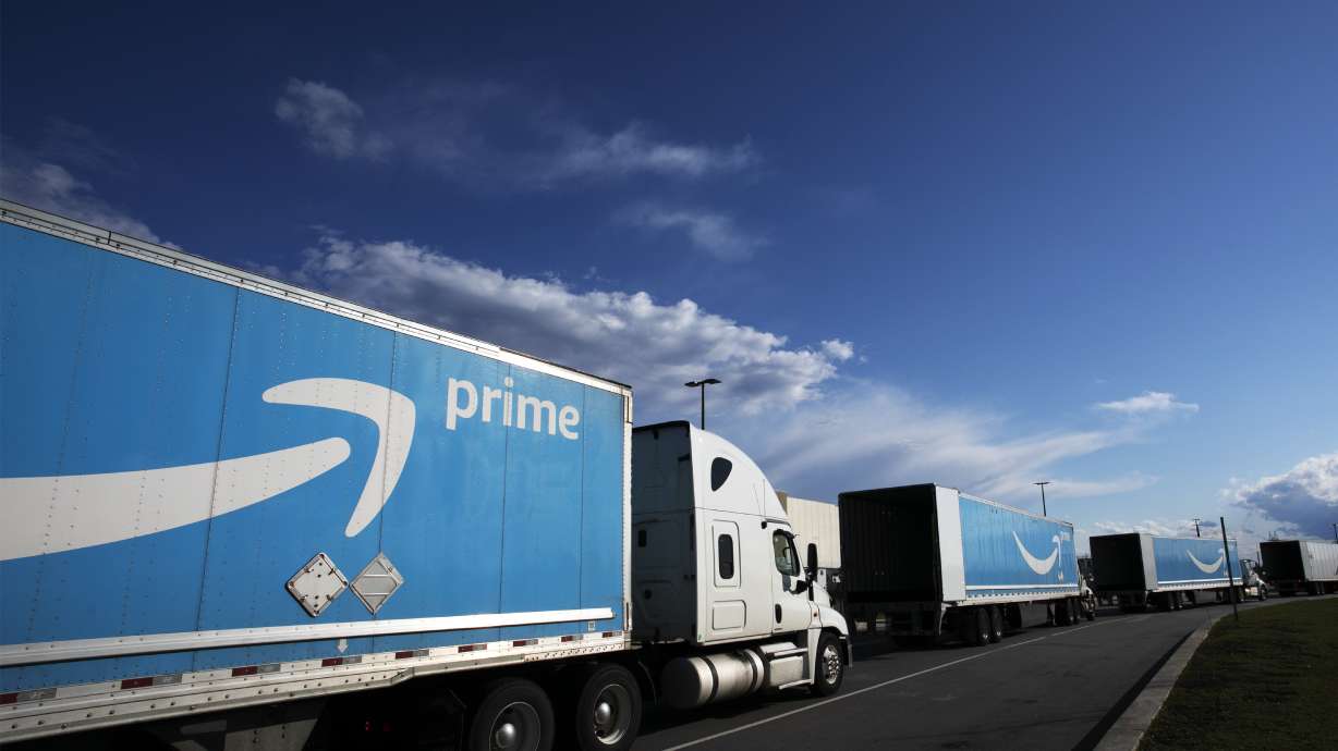 FILE - This April 21, 2020 file photo shows Amazon tractor-trailers line up outside the Amazon Fulfillment Center in the Staten Island borough of New York. Amazon said Wednesday, June 2, 2021, that it will hold its annual Prime Day over two days in June this year, the earliest it has ever held the sales event. (AP Photo/Mark Lennihan, File)