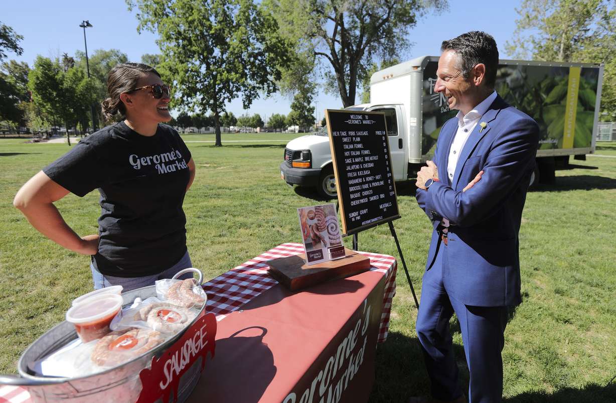 Tara Gerome, co-owner of Gerome’s Market, talks to Derek Miller, president and CEO of the Salt Lake Chamber and Downtown Alliance, during the kickoff press conference for the Downtown Farmers Market at Pioneer Park in Salt Lake City on Wednesday, June 2, 2021.The market's 30th season starts Saturday, June 5, at the park. Tara and her husband, Craig Gerome, are the fourth generation to make their family’s sausage.