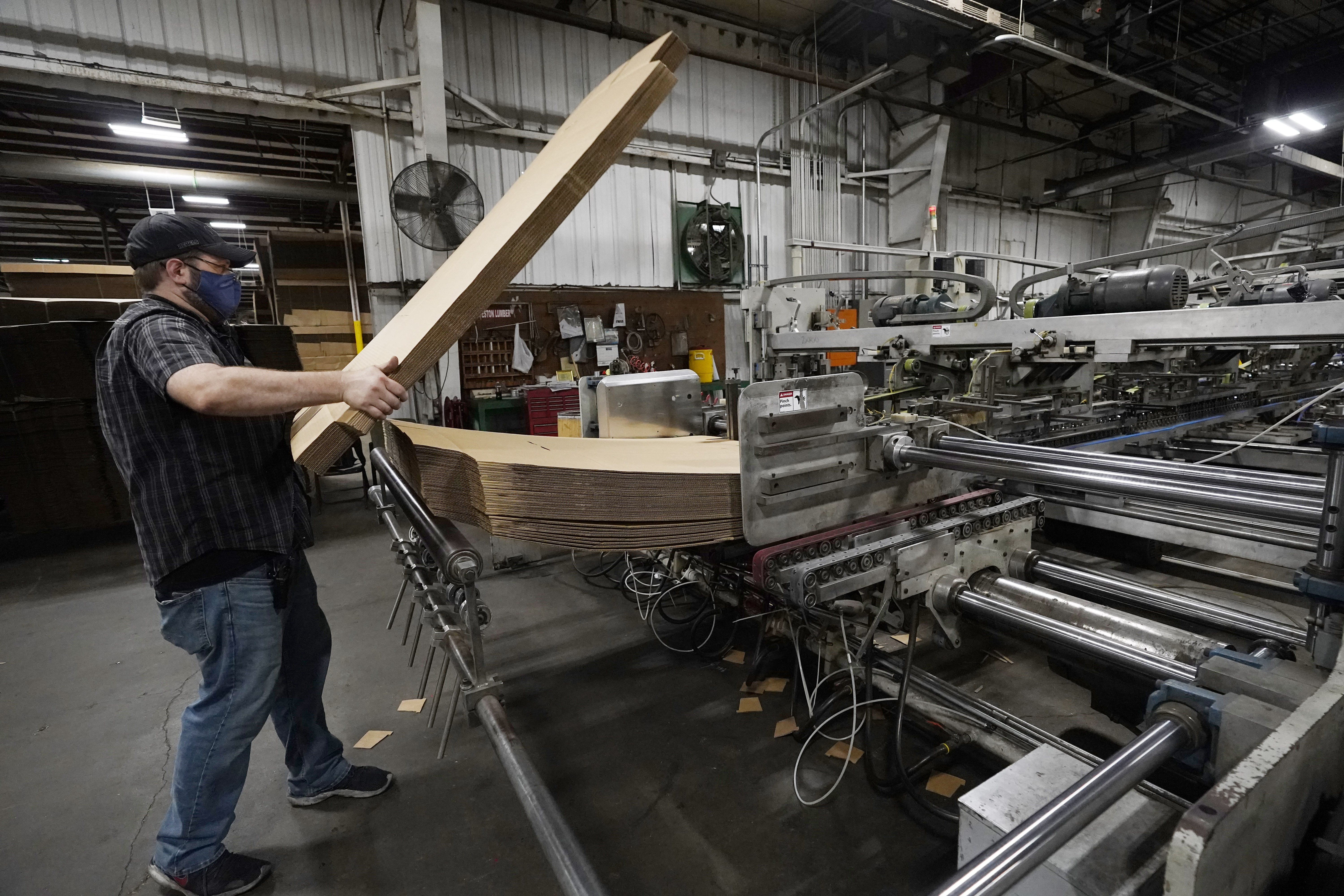 Rob Bondurant, a supervisor at Great Southern Industries, a packaging company, loads up a finishing machine in the Jackson, Miss., facility, Friday, May 28, 2021. The lack of workers has forced some supervisors to assume additional duties. Charita McCarrol, human resources manager at the company, cites the abuse by some people of the $300-a-week federal supplement for people who lost their jobs during the COVID-19 pandemic, as well as other programs that offered extended support for the unemployed, with providing a soon to end financial staple. She also cited that for some people, a steady paycheck and benefits like health care, are not enough of an incentive to pass up the expiring benefits. (AP Photo/Rogelio V. Solis)