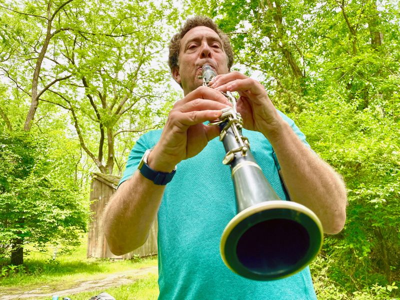 FILE PHOTO: David Rothenberg, a professor of philosophy and music at the New Jersey Institute of Technology, plays the clarinet along with the sounds of cicadas at a nature preserve in Princeton, New Jersey, U.S., June 2, 2021. Picture taken June 2, 2021. REUTERS/Kevin Fogarty/File Photo