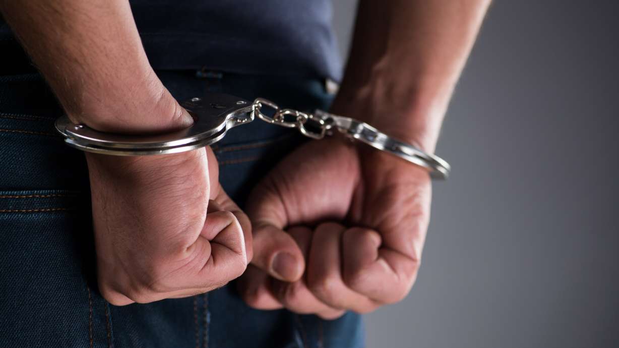 A man is handcuffed. Handcuffs