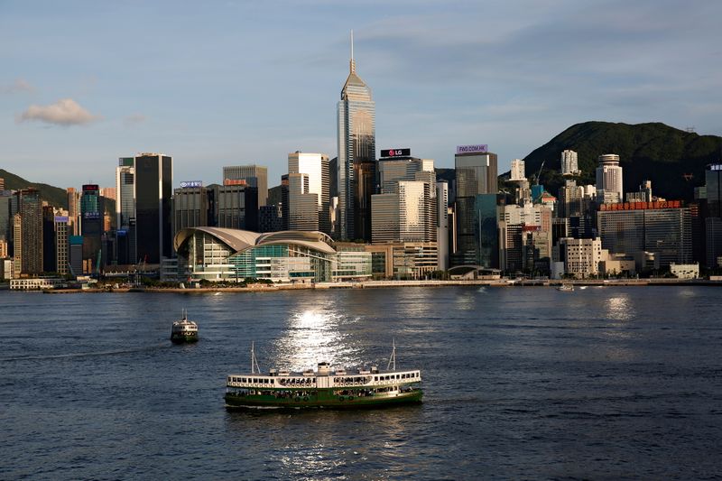 FILE PHOTO: A Star Ferry boat crosses Victoria Harbour in front of a skyline of buildings in Hong Kong, China June 29, 2020. REUTERS/Tyrone Siu