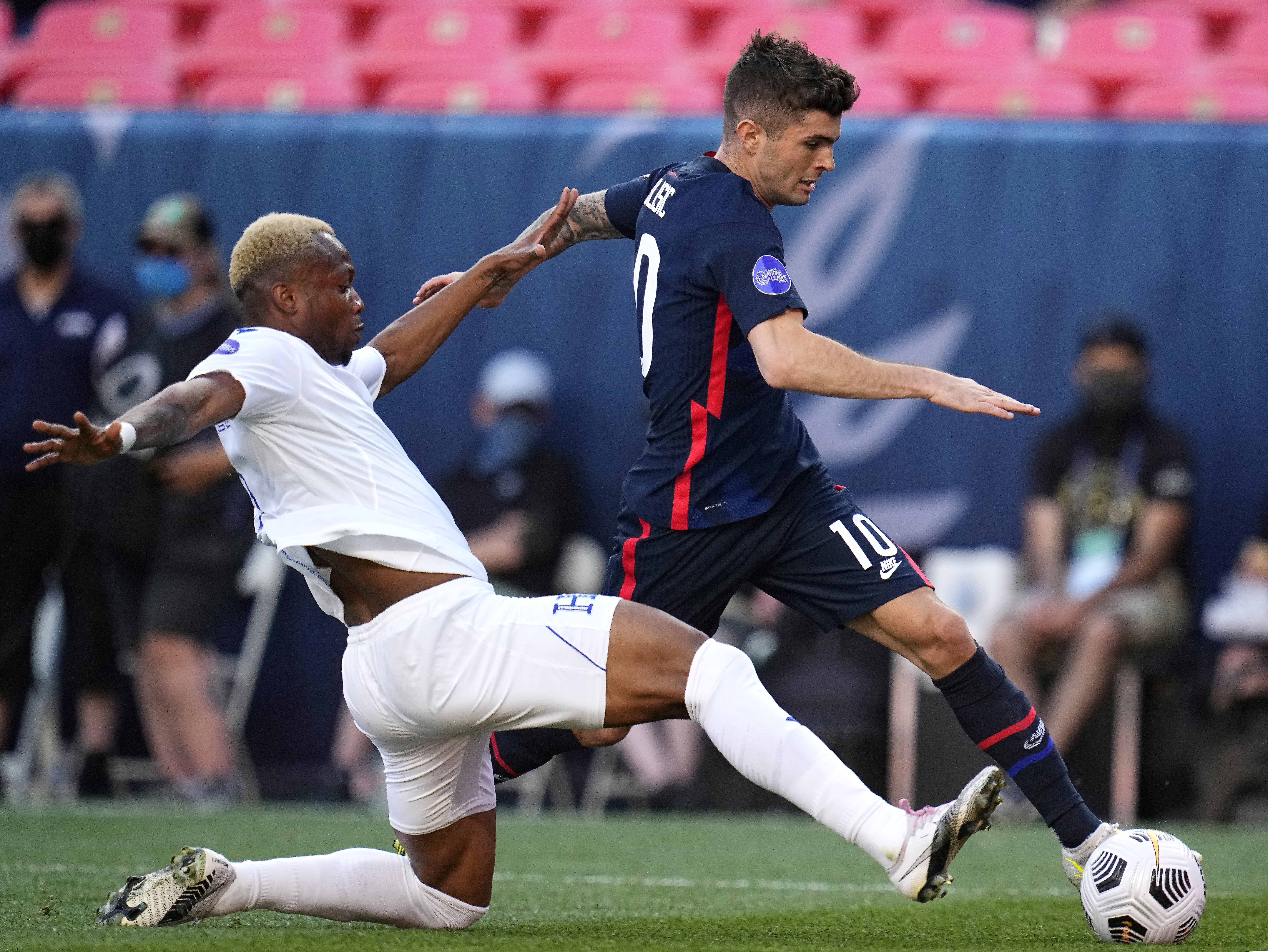 United States' Christian Pulisic (10) moves the ball against Honduras' Kevin Álvarez during the first half of a CONCACAF Nations League soccer final Thursday, June 3, 2021, in Denver.