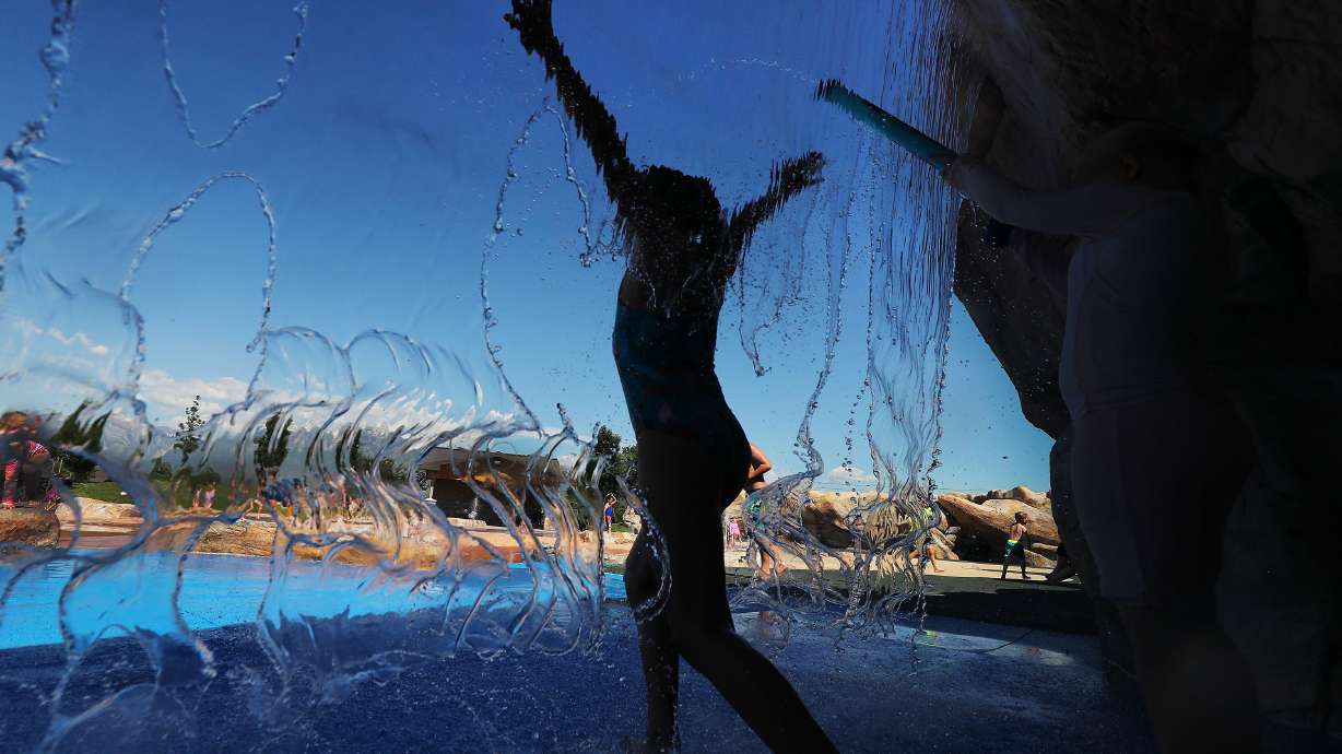 Children cool off in the water at Wardle Fields Regional Park splash pad in Bluffdale on Thursday, June 3, 2021.