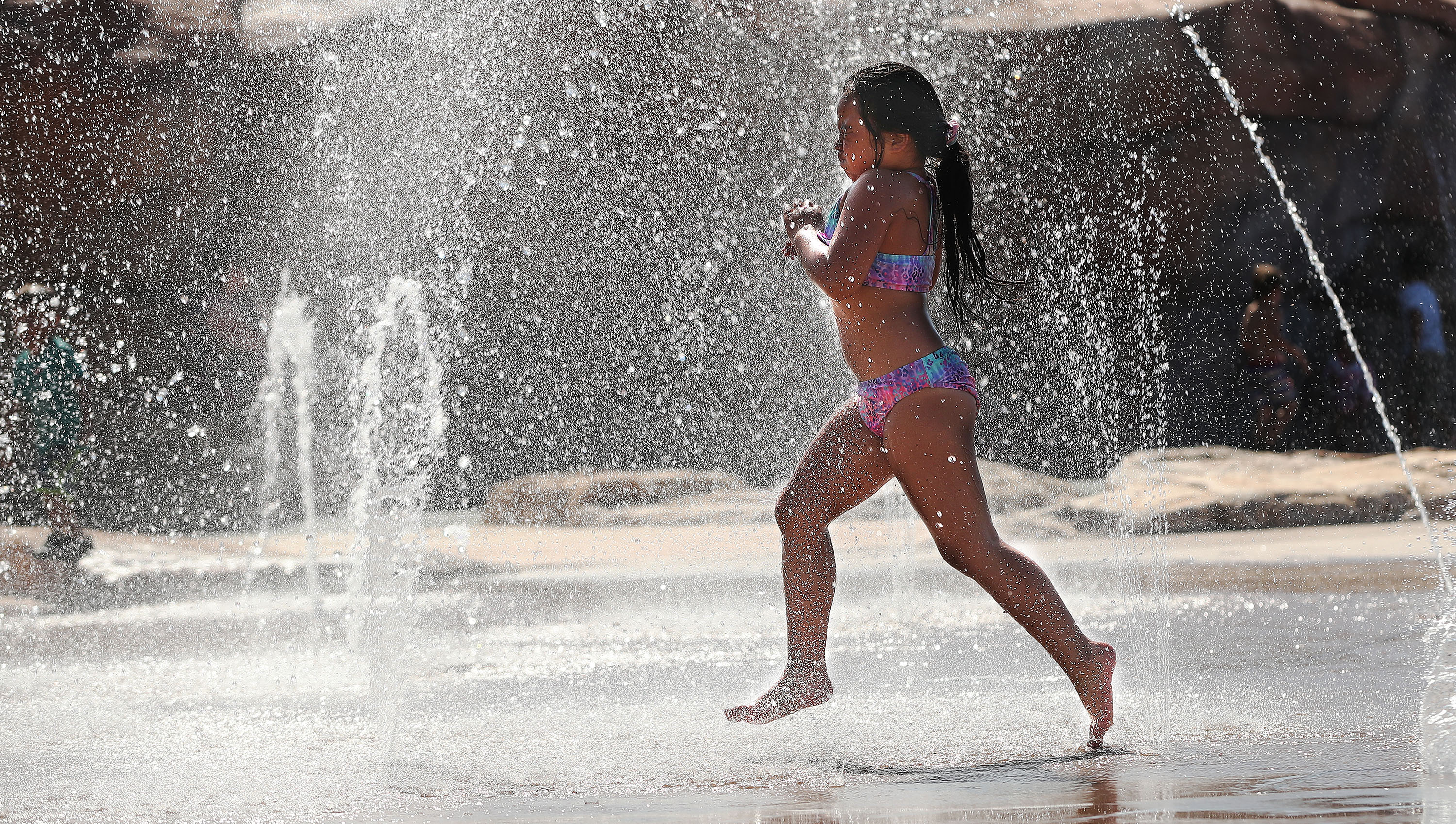 Mahkenah Lacour cools off in the water at Wardle Fields Regional Park splash pad in Bluffdale on Thursday, June 3, 2021.