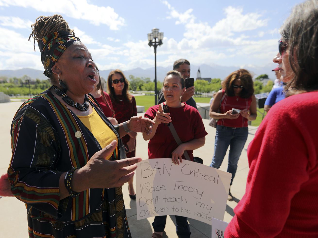 Betty Sawyer, left, a supporter of critical race
theory, exchanges views with a group of women opposed to the
theory, after a protest organized by the Utah Educational Equity
Coalition outside of the Capitol in Salt Lake City on May
19. The president of Utah’s largest teacher association urged
The Utah State Board of Education Thursday to "own” its position of
general control of the Utah public education system as the board
prepares to address educational equity in schools and educator
standards.
