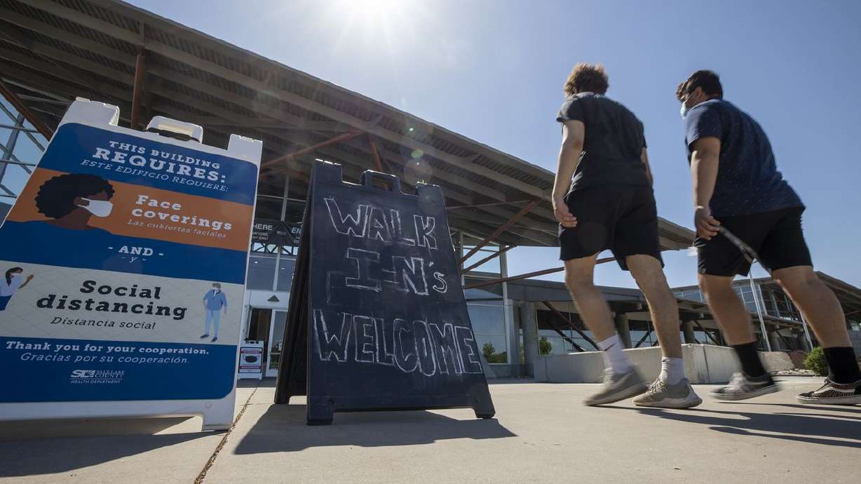 People arrive at the Mountain America Exposition Center in Sandy to receive COVID-19 vaccinations on Tuesday, May 18, 2021. While other states may be offering residents who get vaccinated against COVID-19 an increasingly wide range of incentives, Utah is not.