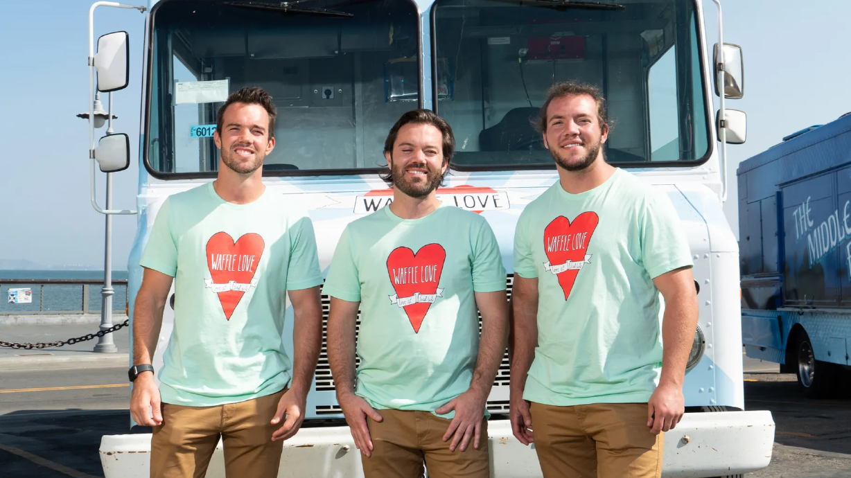 Brothers Steve, Adam and Jared Terry pose for a photo in front of a Waffle Love food truck. The Utah-born business is competing on Food Network’s “The Great Food Truck Race: All Stars,” which premieres June 6.