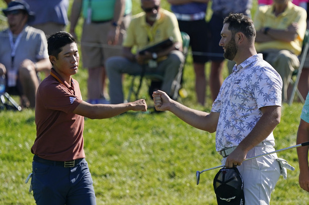 Collin Morikawa fist bumps Jon Rahm following the second round of the Memorial golf tournament, Saturday, June 5, 2021, in Dublin, Ohio.