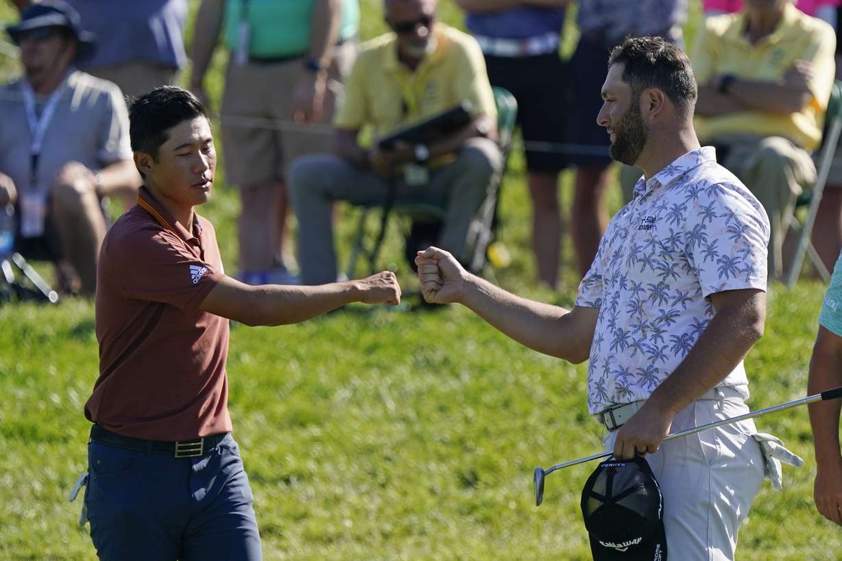 Collin Morikawa fist bumps Jon Rahm following the second round of the Memorial golf tournament, Saturday, June 5, 2021, in Dublin, Ohio.
