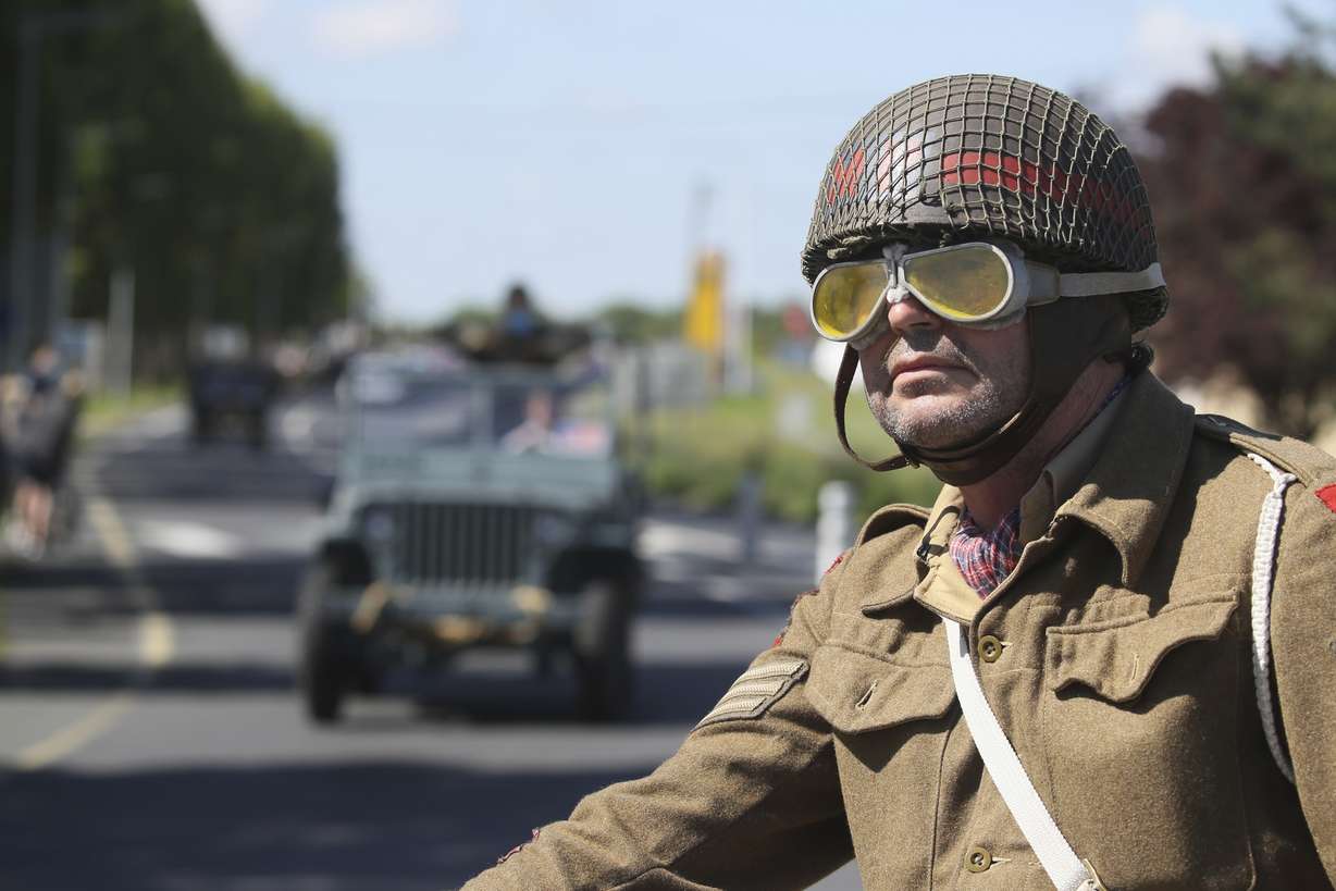 World War II history enthusiasts parade in WWII vehicles in Ouistreham, Normandy, Saturday June 5, 2021, on the eve of 77th anniversary of the assault that helped bring an end to World War II. While France is planning to open up to vaccinated visitors starting next week, that comes too late for the D-Day anniversary. So for the second year in a row, most public commemoration events have been canceled. A few solemn ceremonies have been maintained, in the presence of dignitaries and a few guests only.