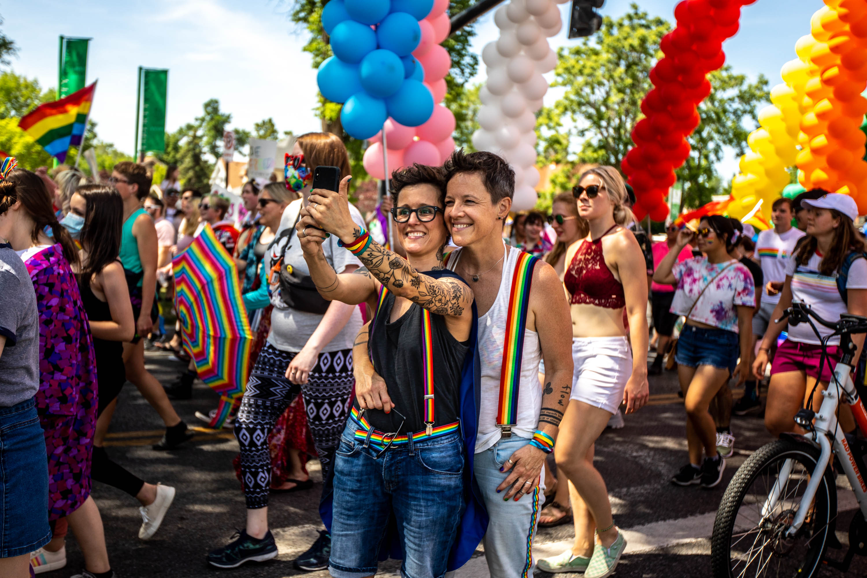 Two individuals pause briefly to take a selfie during the Rainbow March and Rally that began at the state Capitol before heading to Liberty Park in Salt Lake City on Sunday, June 6, 2021. The event was part of Pride Week activities to support Utah's LGBTQ community.