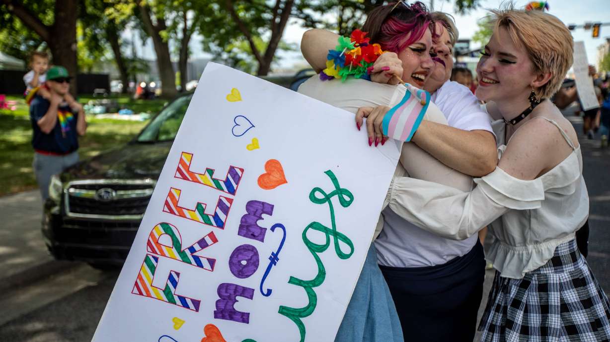 Robin Cavaness, center, offers hugs to those marching during the Rainbow March and Rally in Salt Lake City on June 6, 2021. The Huntsman Mental Health Institute hosted a panel Wednesday to highlight and discuss mental health struggles among the LGBTQ community as Pride month nears an end.