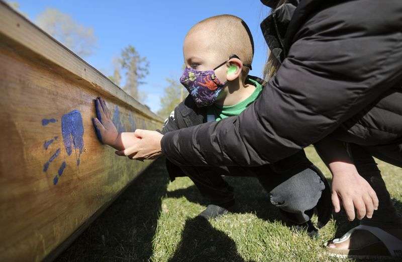 Kahnrad Koontz, a pre-k student at the Utah Schools for
the Deaf and the Blind, puts his handprint on All Hands on Deck, a
boat built by students and staff, outside of the Openshaw Education
Center in Millcreek on April 20. The school’s yacht club took part
in the SEVENTY48, a 70-mile human-powered boat race from Tacoma to
Port Townsend, Washington, but was unable to finish the race
Saturday night.