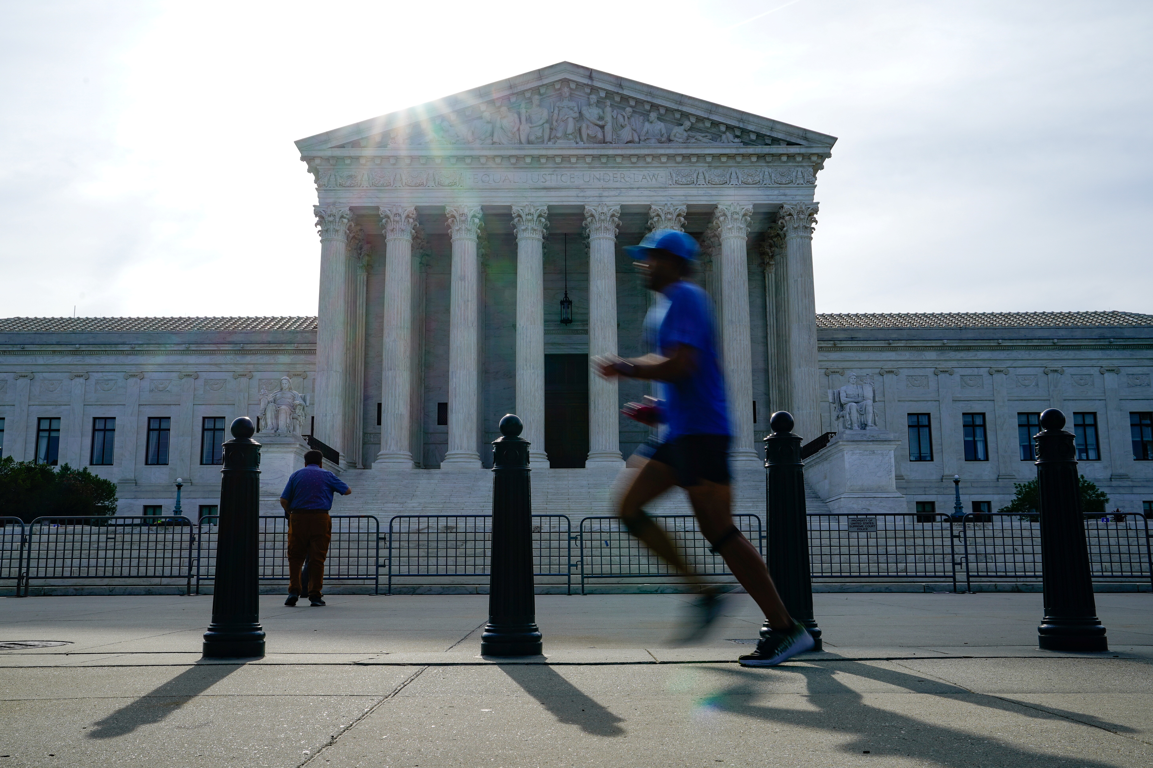 FILE: People walk past the U.S. Supreme Court the day the court is set to release orders and opinions in Washington, U.S., June 1, 2021. Reuters/Erin Scott