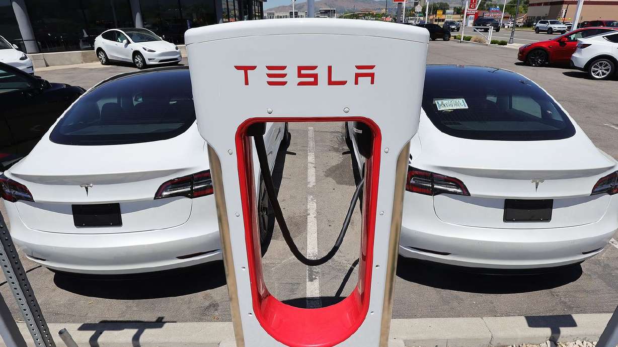 Electric cars charge at the Tesla dealership in Salt
Lake City on Friday, June 4, 2021. Disruptions to production of
semiconductor chips have led to inventory shortages and record
prices for new electric cars.