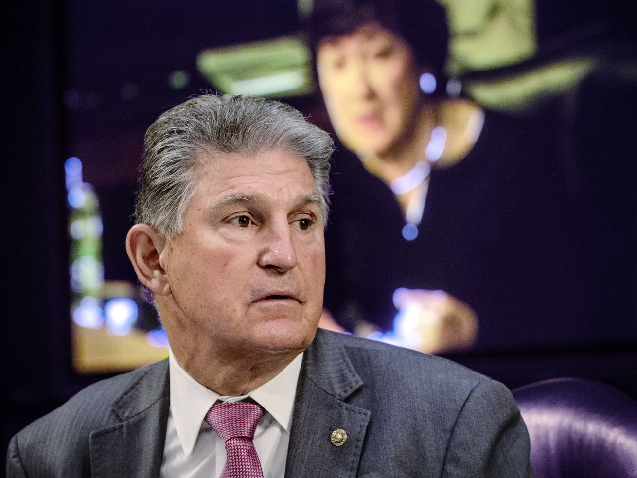 Sen. Joe Manchin, D-W.Va., listens as Sen. Susan
Collins, R-Maine, on the monitor behind him, asks questions during
a hearing on Capitol Hill in Washington on May 12, 2021. Manchin’s
opposition to the massive elections reform package likely dooms
legislation that a Utah senator has said was written by the "devil
himself.”