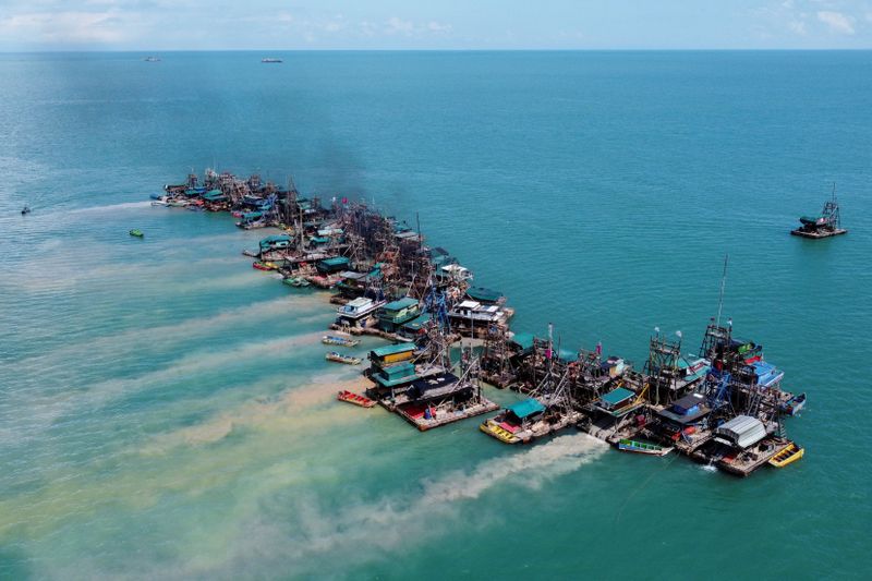 An aerial view shows wooden pontoons equipped to dredge the seabed for deposits of tin ore off the coast of Toboali, on the southern shores of the island of Bangka, Indonesia, May 1, 2021. Picture taken with a drone. REUTERS/Willy Kurniawan