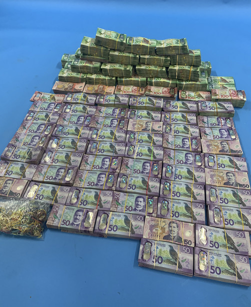 In this undated photo supplied by the New Zealand police, a large amount of cash is displayed during a police raid as part of Operation Trojan. Authorities in Australia and New Zealand said Tuesday, June 8, 2021, they've dealt a huge blow to organized crime after hundreds of criminals were tricked into using a messaging app that was being secretly run by the FBI. (New Zealand Police via AP)