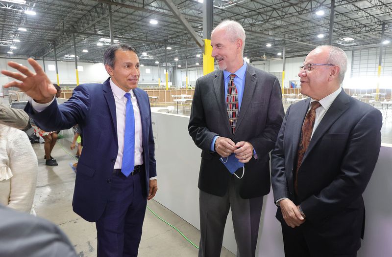 Elder Arthur Rascon, Area Seventy of The Church of
Jesus Christ of Latter-day Saints, left, Jeff Watkins, YMCA, and
Elder Carlos Villarreal, Area Seventy of The Church of Jesus Christ
of Latter-day Saints, talk prior to a press conference at the
Family Transfer Center in Houston on Monday, June 7, 2021.