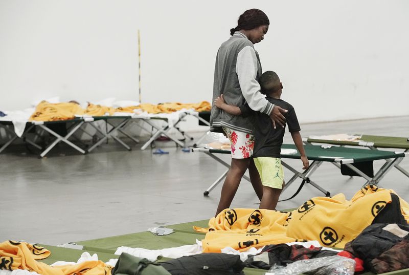 Haitian refugee Valeria Lamour walks with son Abisay Lamour at the Family Transfer Center in Houston on Monday, June 7, 2021. The center provides a temporary respite for families who have been cleared at the U.S. border and need short-term shelter and food.