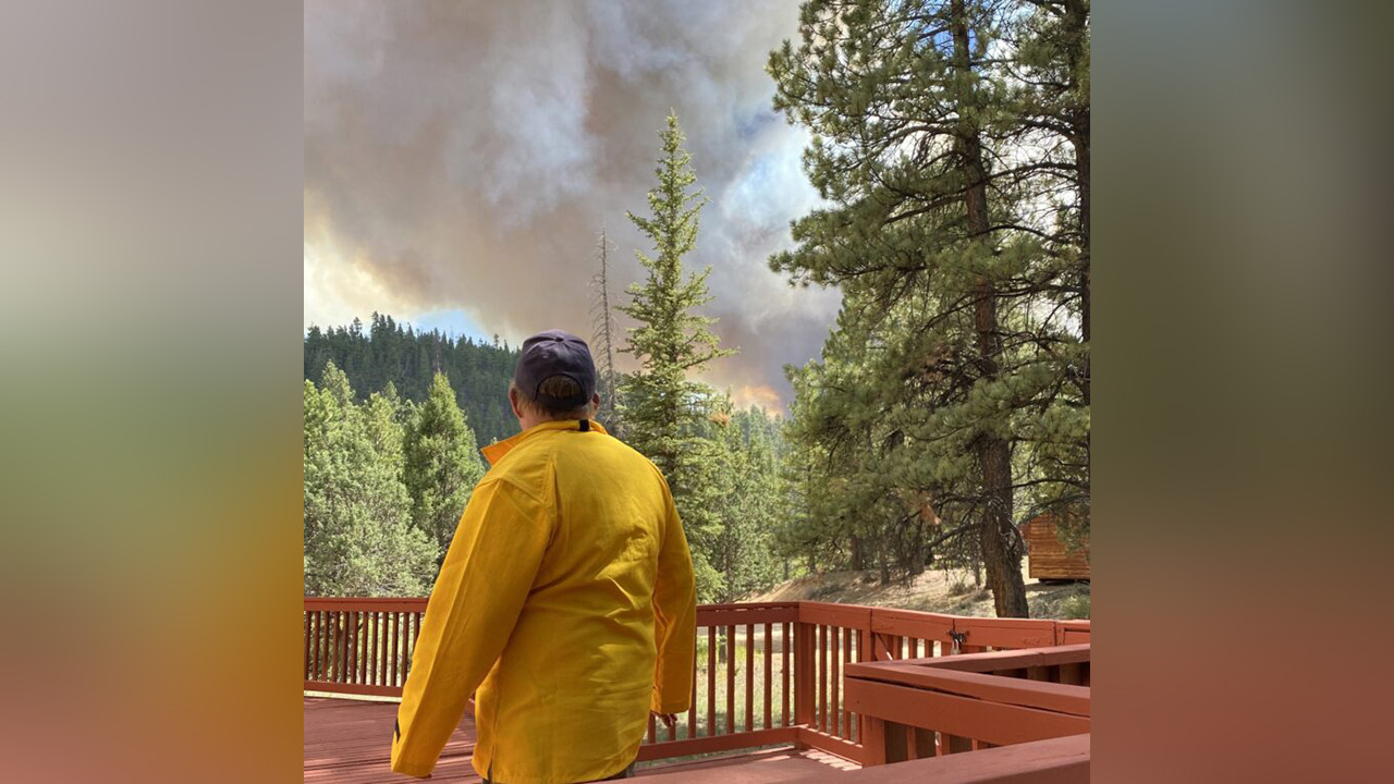 A volunteer firefighter watches the Mammoth Fire from Bob Donaldson’s home in Mammoth Creek Village, Utah, June 5th, 2021.