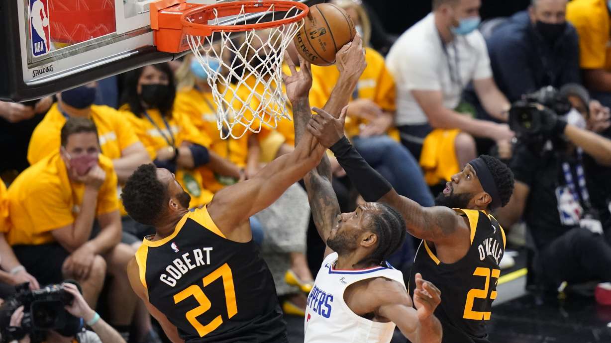 Utah Jazz's Rudy Gobert (27) and Royce O'Neale (23) defend against Los Angeles Clippers forward Kawhi Leonard, center, during the first half of Game 1 of a second-round NBA basketball playoff series Tuesday, June 8, 2021, in Salt Lake City.