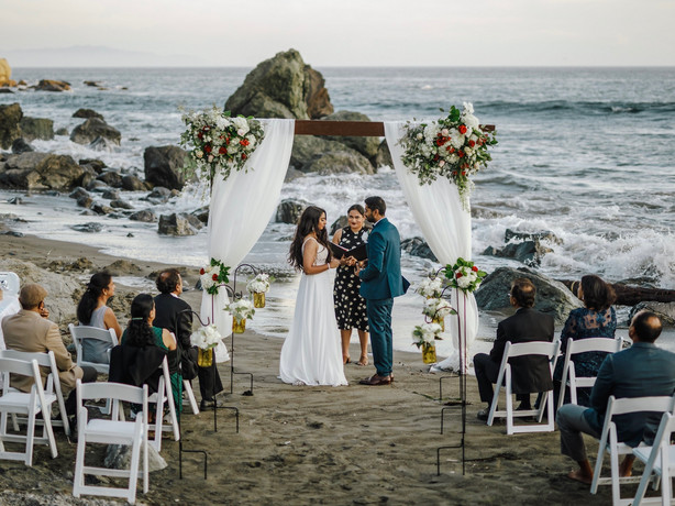 This photo shows bride Namisha Balagopal and groom Suhaas Prasad getting married in a small legal ceremony Aug. 15, 2020, on Muir Beach near San Francisco. The couple plans a larger traditional South Asian Indian wedding this August in Utah amid a boom in post-vaccination nuptials around the world.