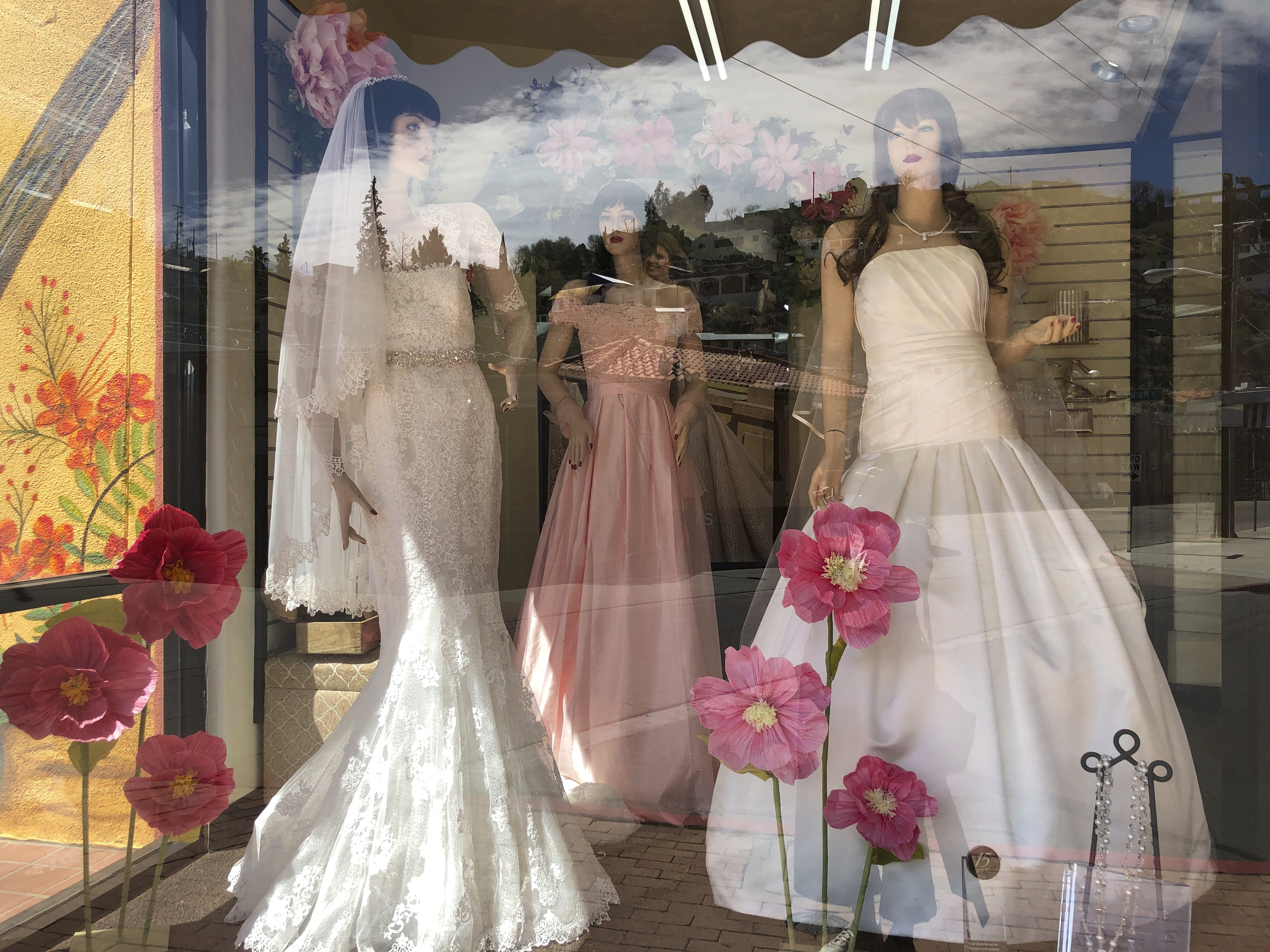 Mannequins in wedding gowns are seen in a window display on March 15, 2021, at a bridal store in Nogales, Ariz., that has been closed for nearly a year because of the pandemic. Couples in the U.S. are racing to the altar amid a vaccination-era wedding boom that has venues and other vendors in high demand. 
