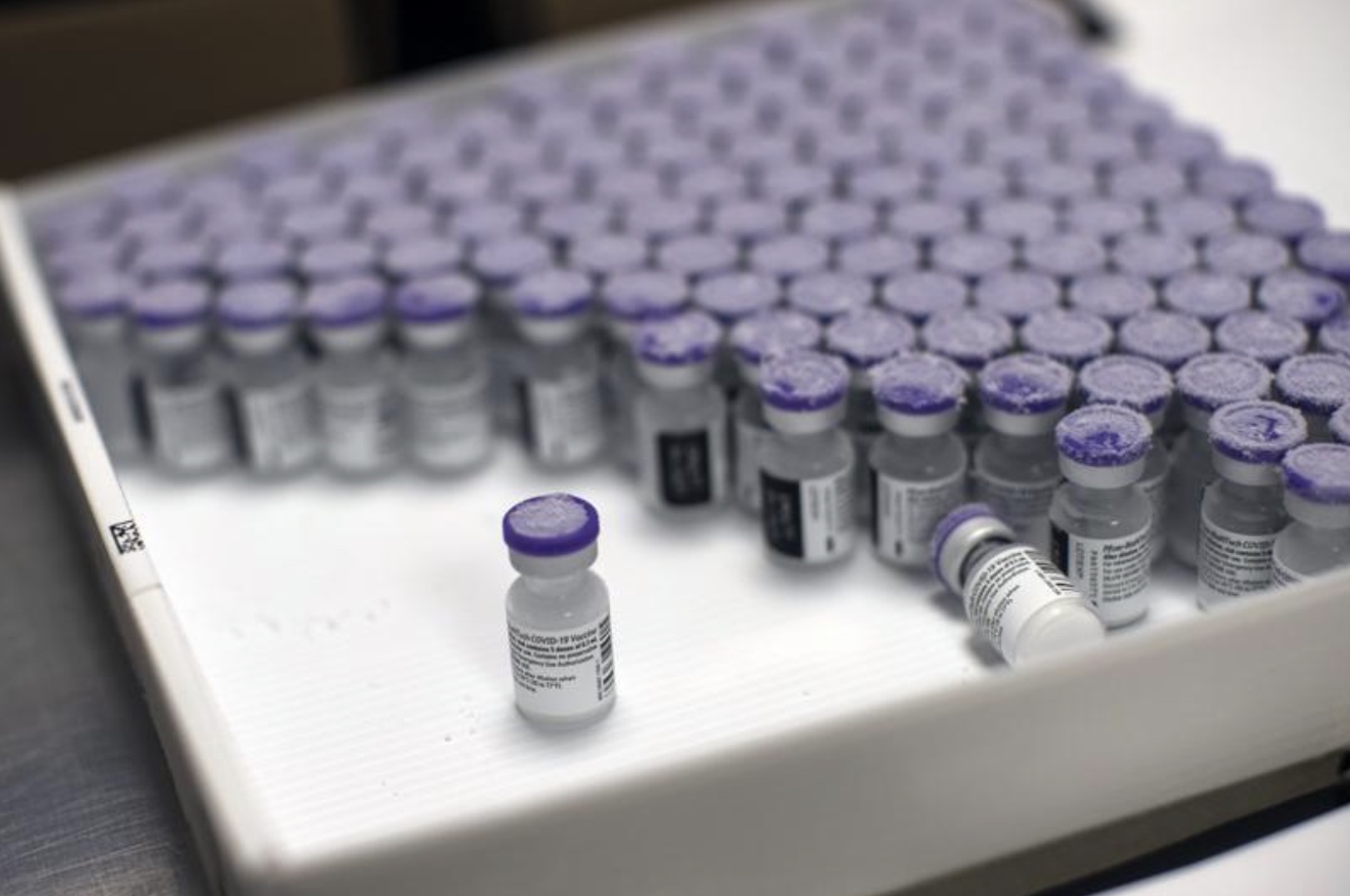 FILE: In this Monday, Jan. 4, 2021 file photo, frozen vials of the Pfizer/BioNTech COVID-19 vaccine are taken out to thaw, at the MontLegia CHC hospital in Liege, Belgium. The U.S. will buy 500 million more doses of the Pfizer COVID-19 vaccine to share through the COVAX alliance for donation to 92 lower-income countries and the African Union over the next year, a person familiar with the matter said Wednesday. (AP Photo/Francisco Seco, File)