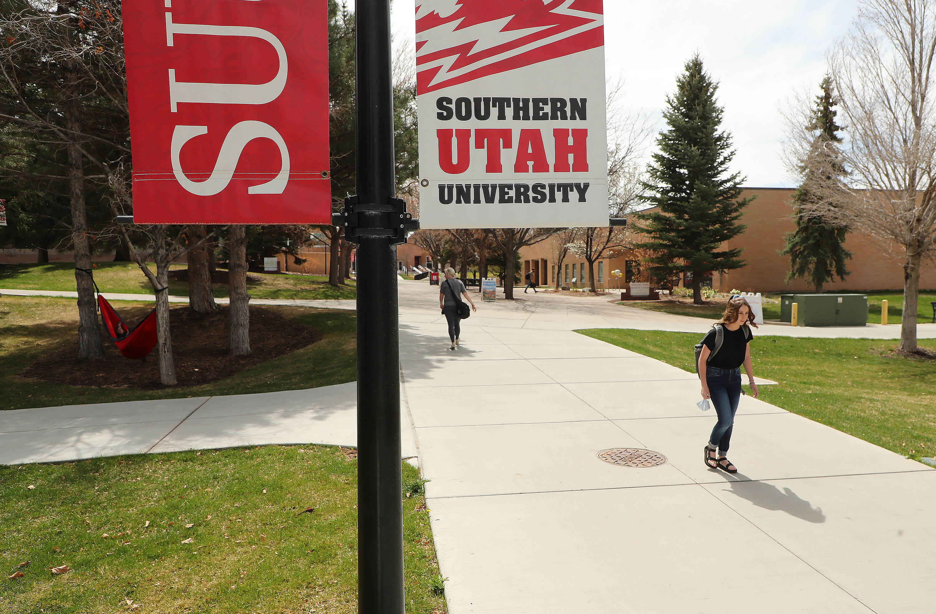 People walk at Southern Utah University in Cedar City on April 7, 2021. University officials say they are short as much as 1,000 beds for students enrolled in fall semester.
