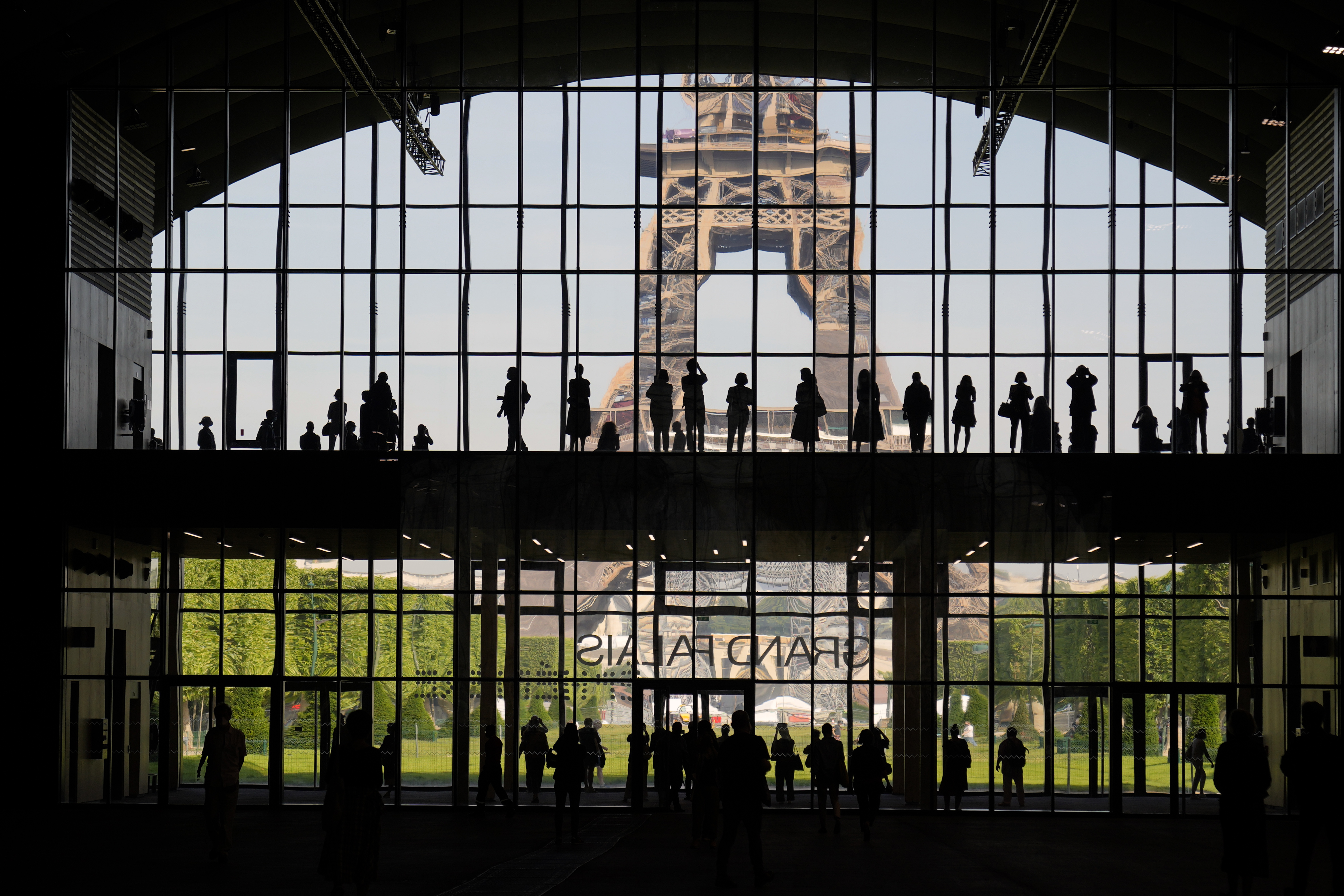 FILE: In this Wednesday, June 9, 2021, photo, visitors gather during a presentation visit of the "Grand Palais Ephemere," with the Eiffel Tower in the background, in Paris. Europe is opening up to Americans and other visitors after more than a year of COVID-induced restrictions.