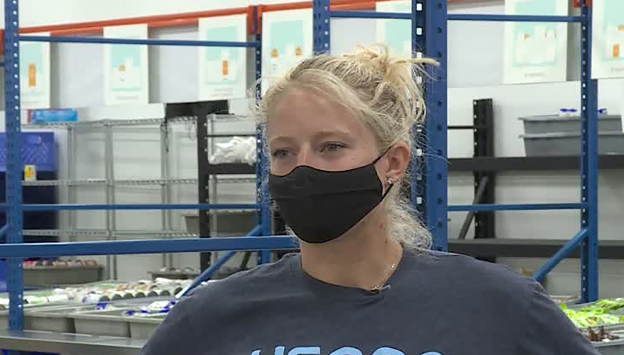 Mia Manganello-Kilburg, who won a Bronze Medal in longtrack speedskating during the 2018 Olympics, helps fill bags with food as part of USANA's Kids Eat program.