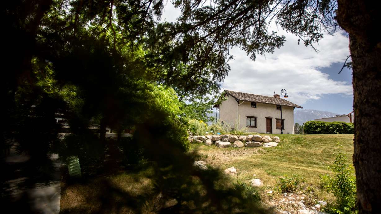 The replica Jehu Cox home sits on an acre of grass across the street from Walmart in Midvale at the Fort Union shopping center on Thursday, June 10, 2021. The owners of the center propose building apartments in the area.