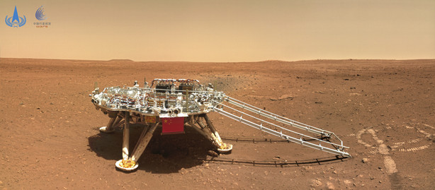 In this image released by the China National Space Administration on Friday, June 11, 2021, the landing platform with a Chinese national flag and outlines of the mascots for the 2022 Beijing Winter Olympics and Paralympics on Mars is seen from the rover Zhurong.
